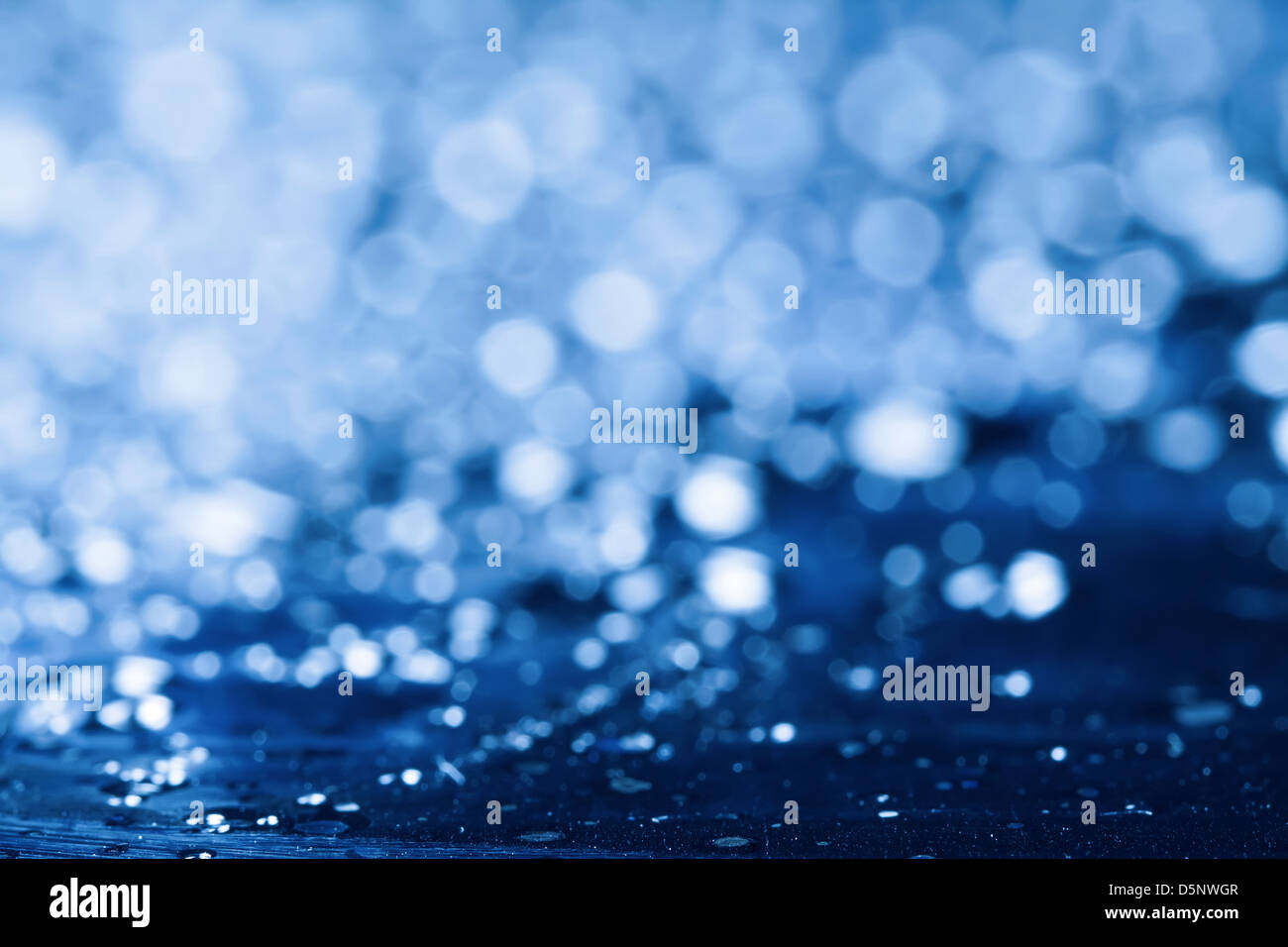 Blue water background with lens flare. Stock Photo