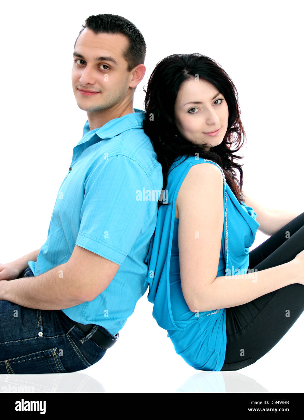 Man and woman sitting on ground and look at the camera Stock Photo