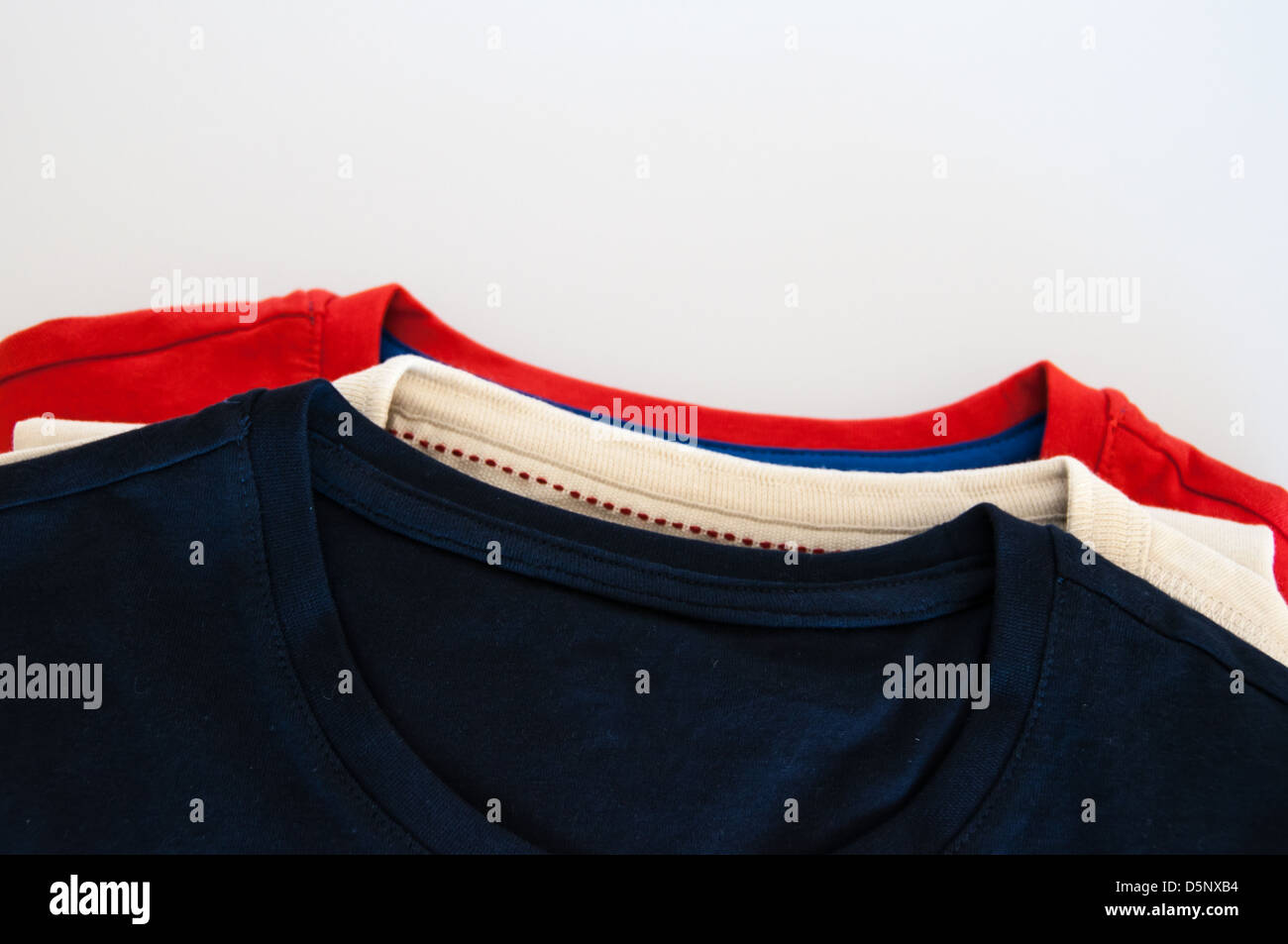 Stack of T Shirts on white background Stock Photo - Alamy