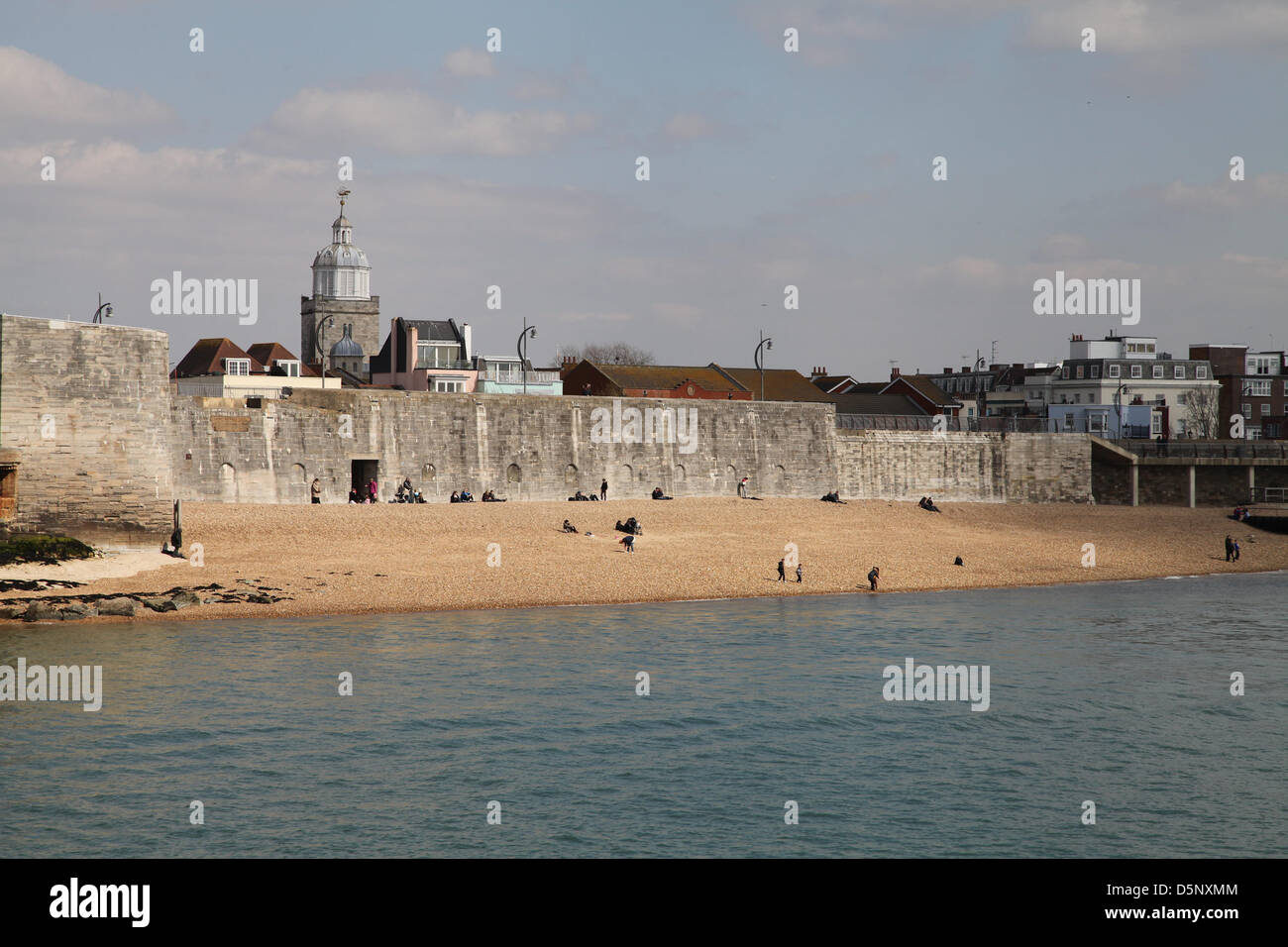 Portsmouth, UK. 6th April 2013 People making the most of the sunshine at the 'hot walls', a local Portsmouth sun bathing spot due to it's slightly warmer conditions. Spring weather was on display today after a poor start to the season. Credit: Rob Arnold/Alamy Live News Stock Photo