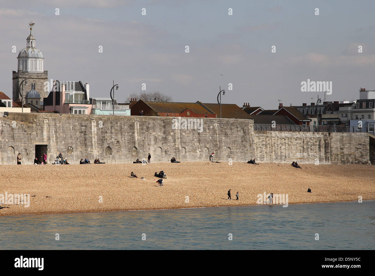 Portsmouth, UK. 6th April 2013 People making the most of the sunshine at the 'hot walls', a local Portsmouth sun bathing spot due to it's slightly warmer, sheltered conditions. Spring weather was on display today after a poor start to the season. Credit: Rob Arnold/Alamy Live News Stock Photo