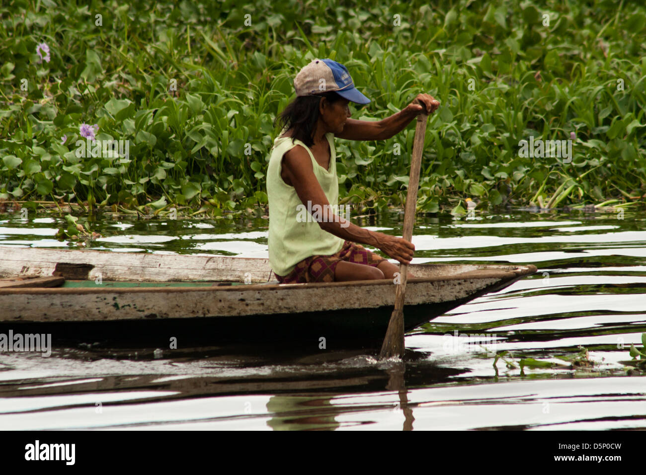 local woman at traditional canoe, somewhere out periphery of Manau, amazonas, Brazil Stock Photo