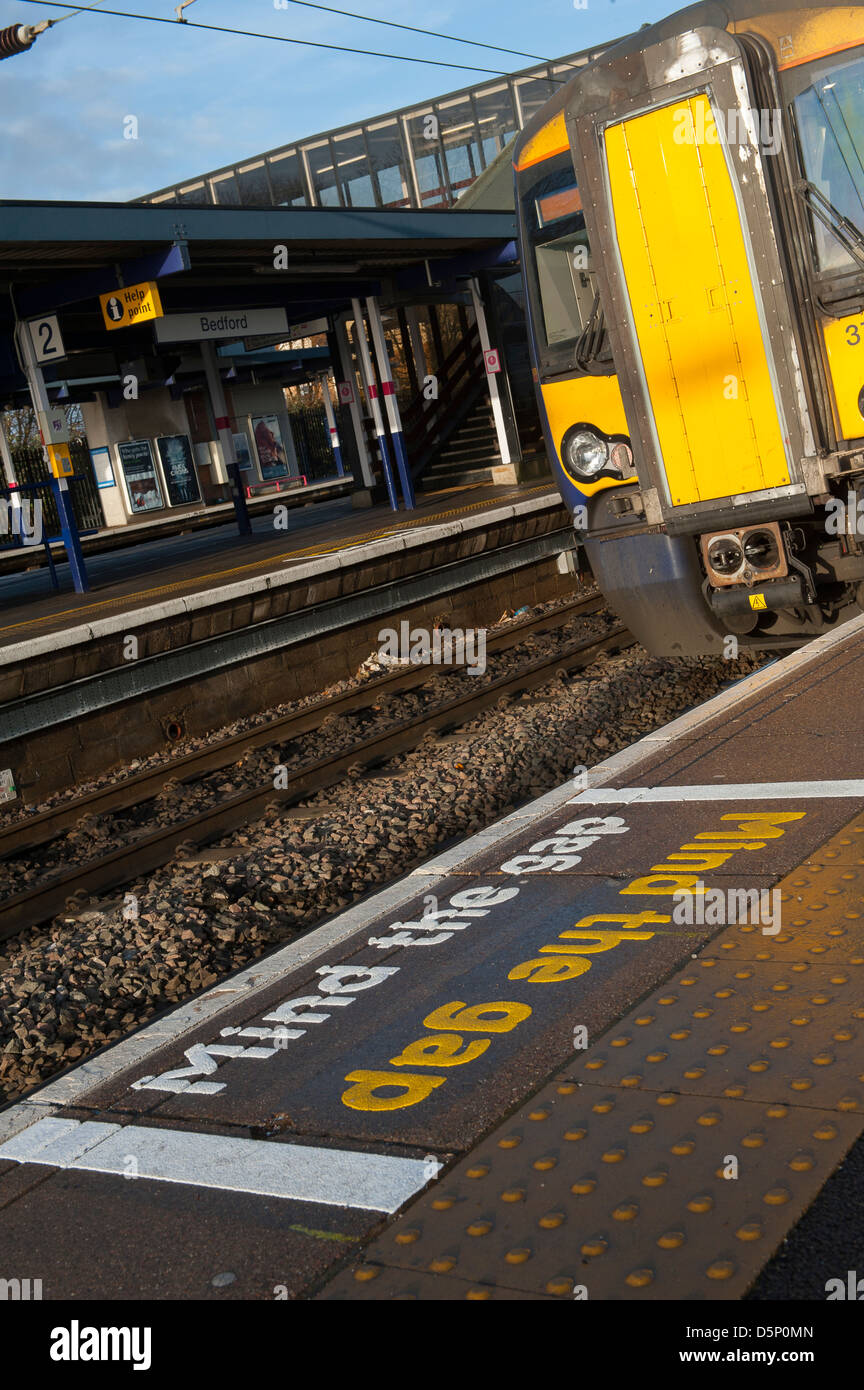Mind the gap sign and tactile paving on Bedford railway station platform, England. Stock Photo