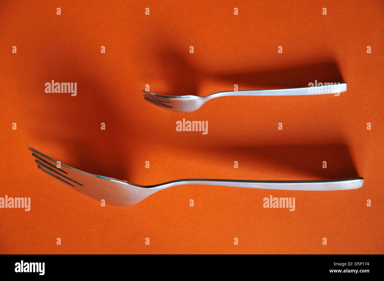 small and large fork Stock Photo Alamy