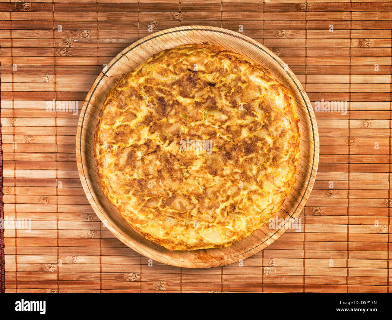 Spanish tortilla on wooden plate. The tortilla is a typical dish in