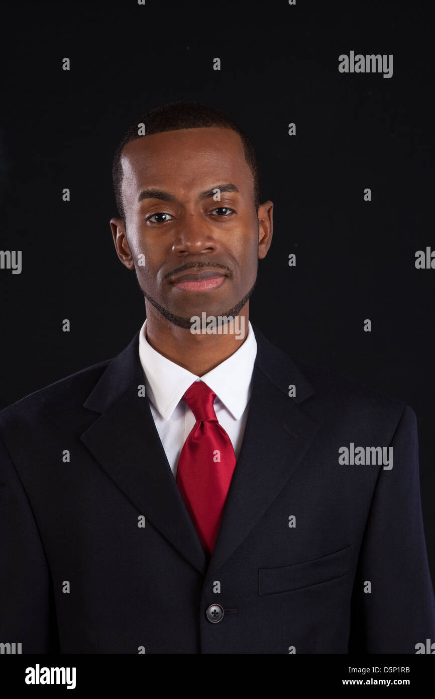 Absurd een vuurtje stoken microscoop Black man in dark suit, white shirt and red tie, a successful, prosperous  businessman, looking thoughtful Stock Photo - Alamy