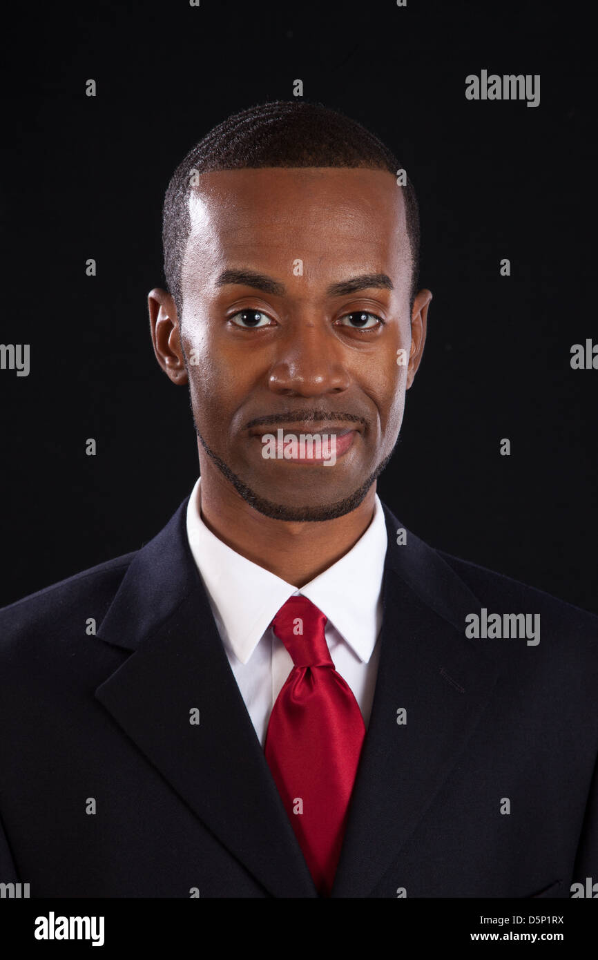 Black man in dark suit, white shirt and red tie, a successful, prosperous  businessman, looking thoughtful and happy Stock Photo - Alamy