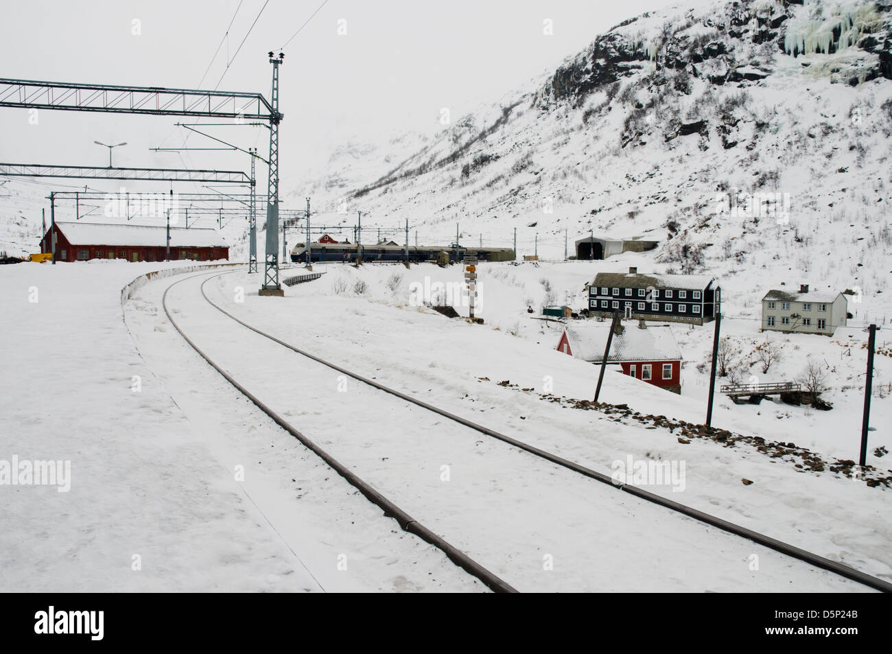 A train on the Oslo to Bergen line pulls into a snowy Myrdal station in the Norwegian Fjords Stock Photo