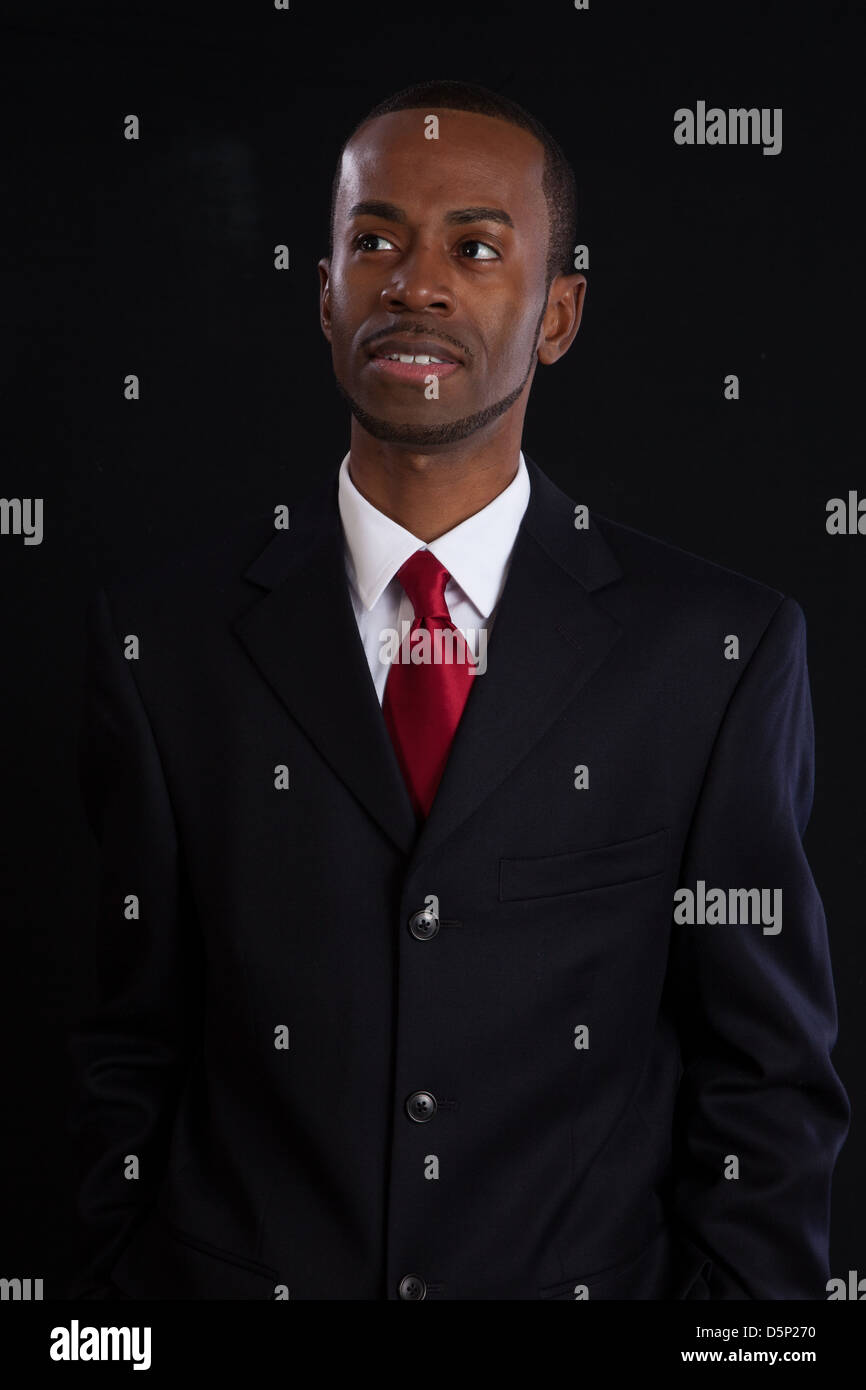 Black man in dark suit, white shirt and red tie, a successful, prosperous  businessman, looking thoughtful Stock Photo - Alamy