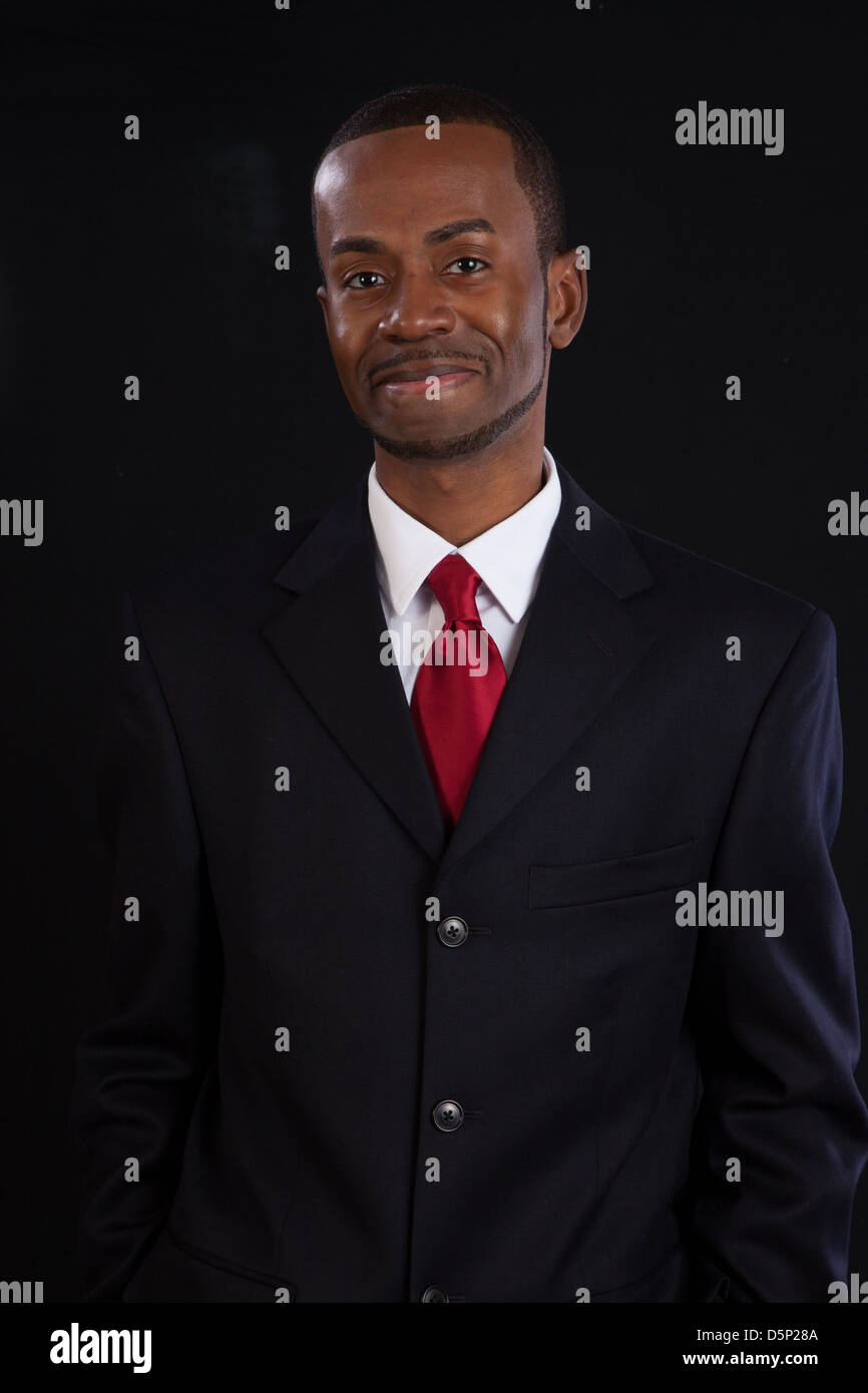 Black man in dark suit, white shirt and red tie, a successful