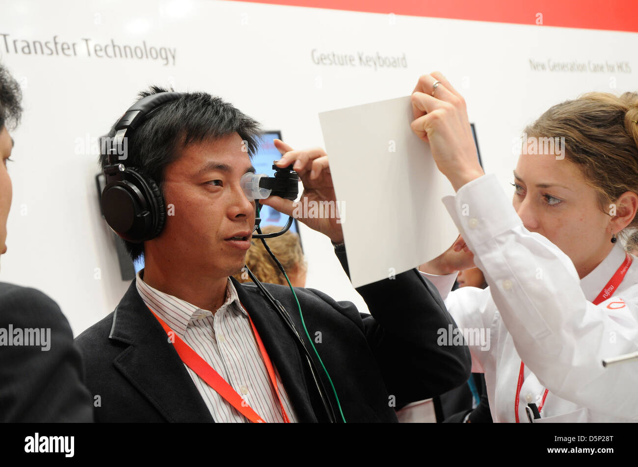 a customer trying a new product at Fujitsu Stand stand at World Mobile Congress in Barcelona 2013. 270213. Stock Photo