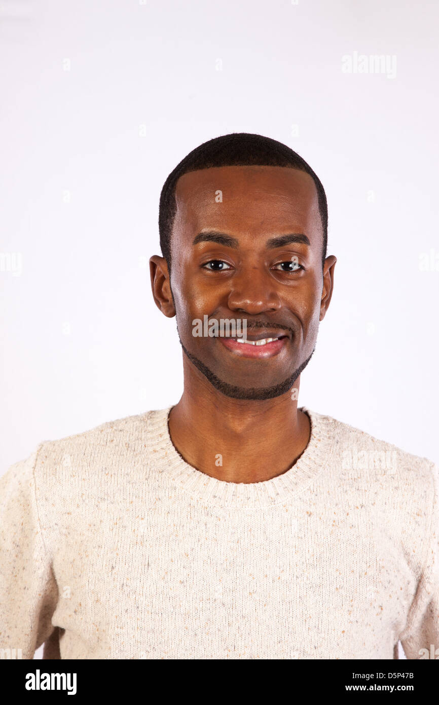 Handsome black man wearing a white pull over sweater,  looking at the camera  with a happy smile Stock Photo