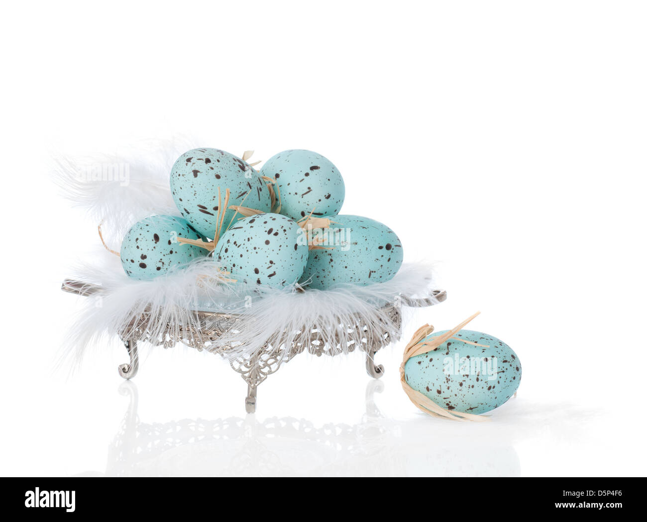 Easter eggs sitting on white feathers Stock Photo