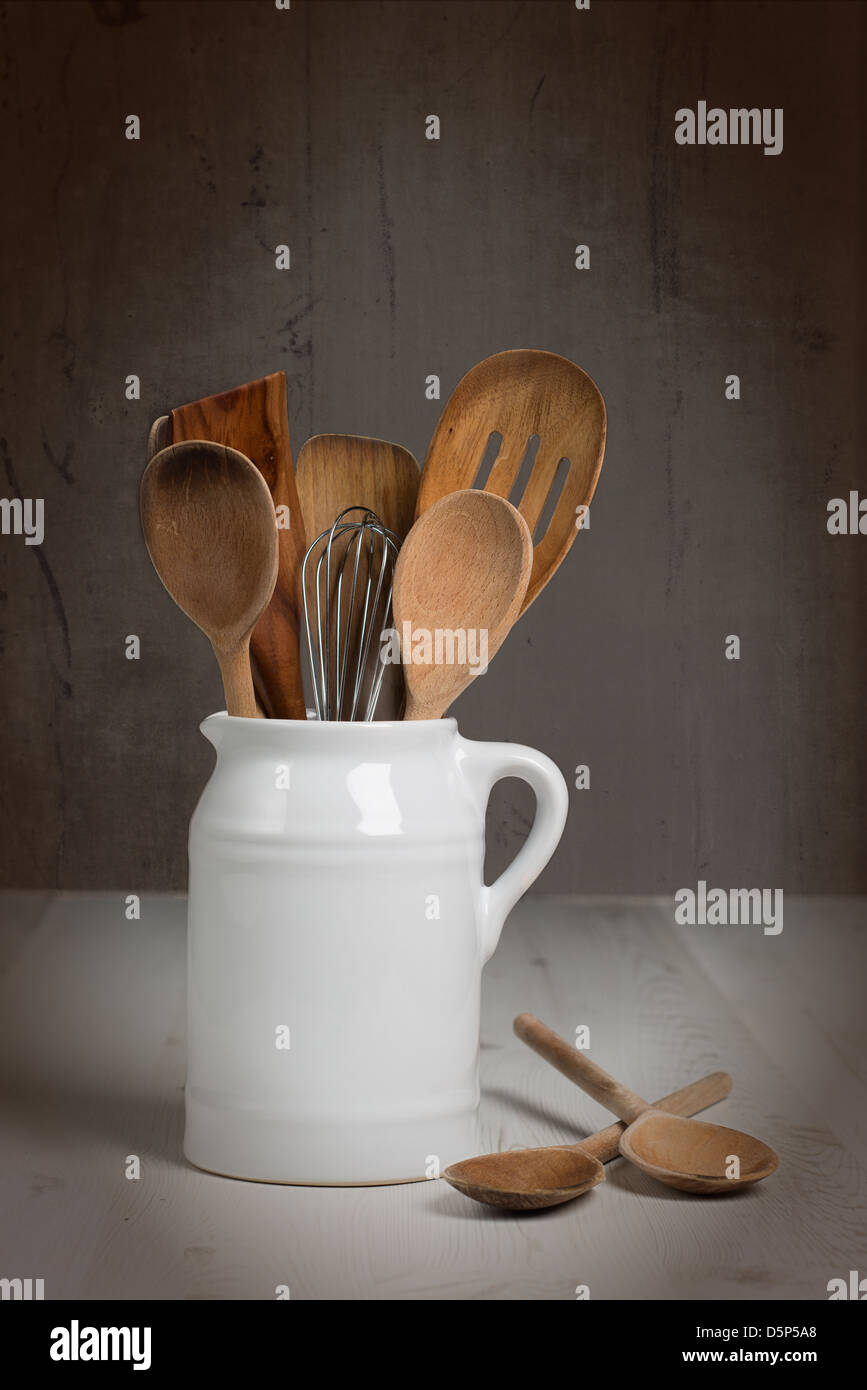 Jug of kitchen utensils including wooden spoons Stock Photo Alamy