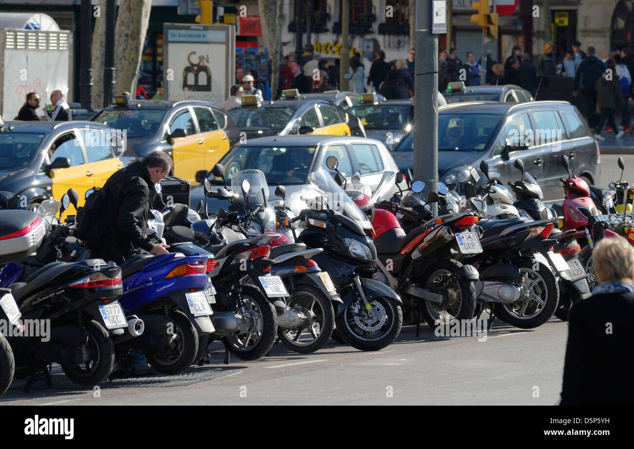 Motorcycles and taxis parked in the city centre. Barcelona. Catalonia