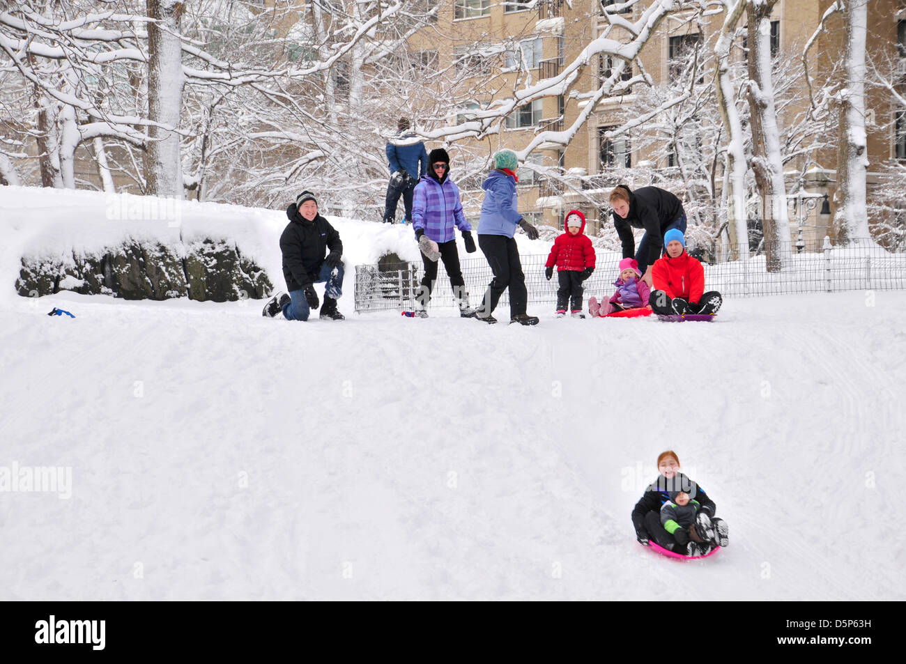 Children sledding during winter storm in Central Park, New York City