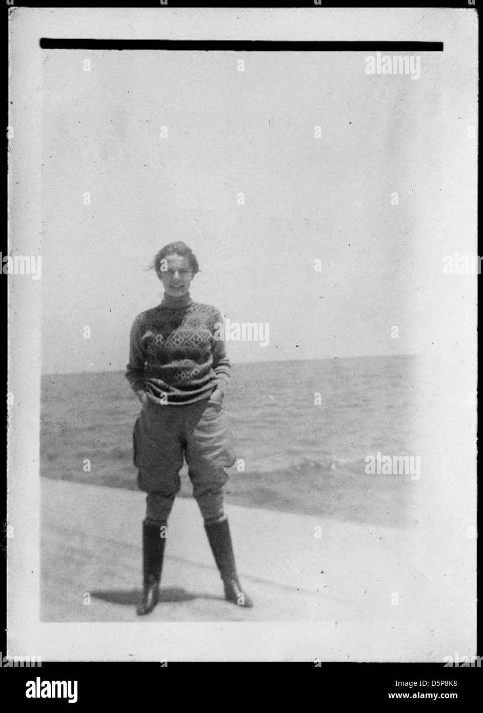 Helen Richey, a notable aviator, is seen standing by the ocean in a ...