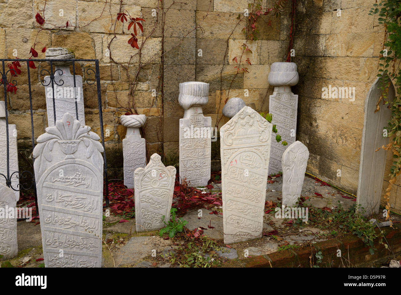 Small Muslim gravestones next to a Mosque in hillside village of