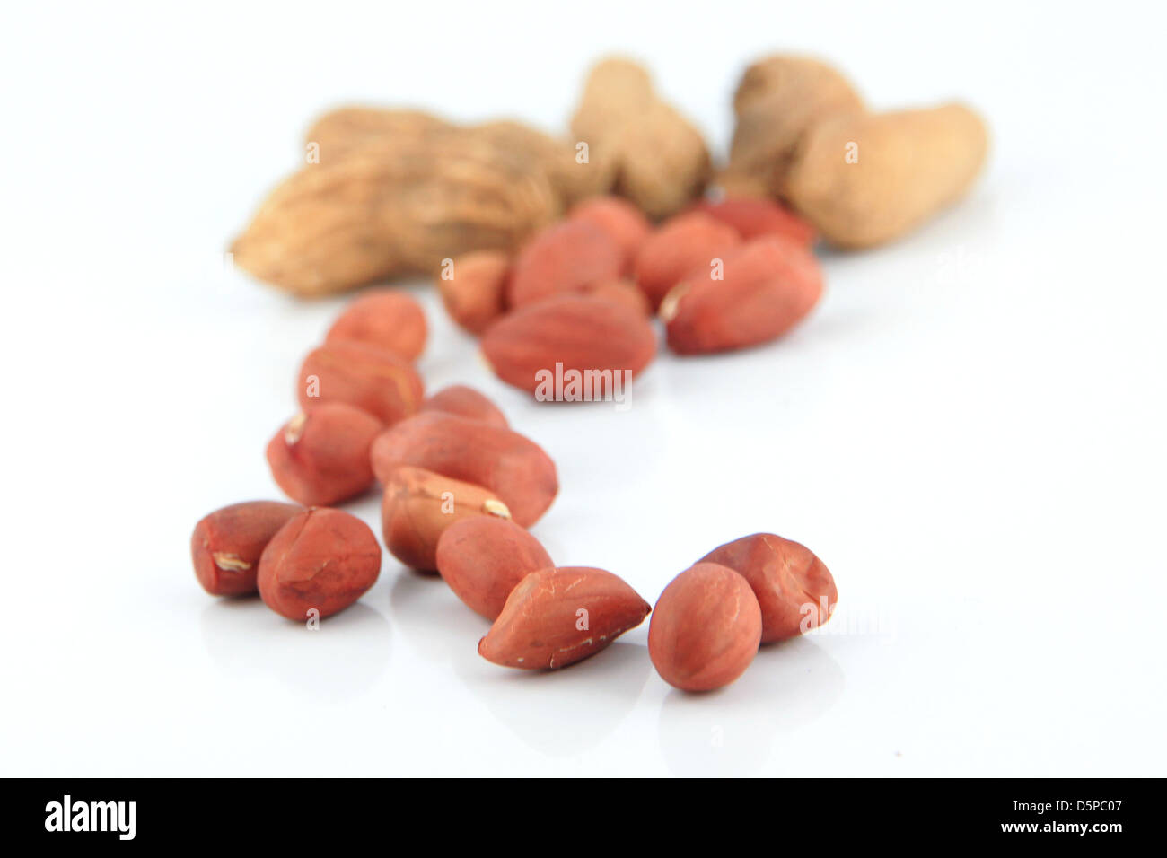 A lot of Peanuts on isolated over white background,focus on foreground. Stock Photo