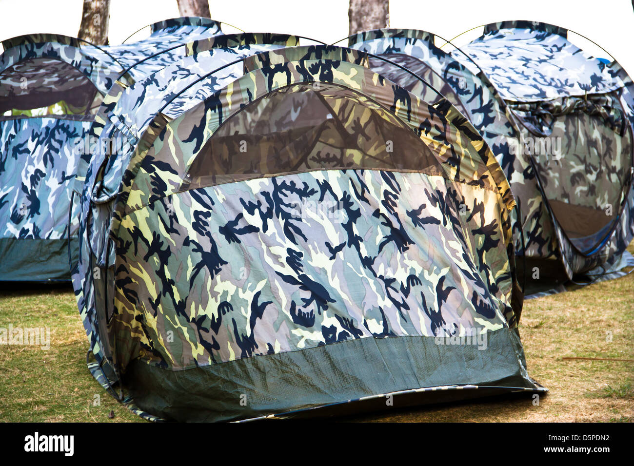 A small canvas tent military pattern is placed on the lawn at the resort  Stock Photo - Alamy
