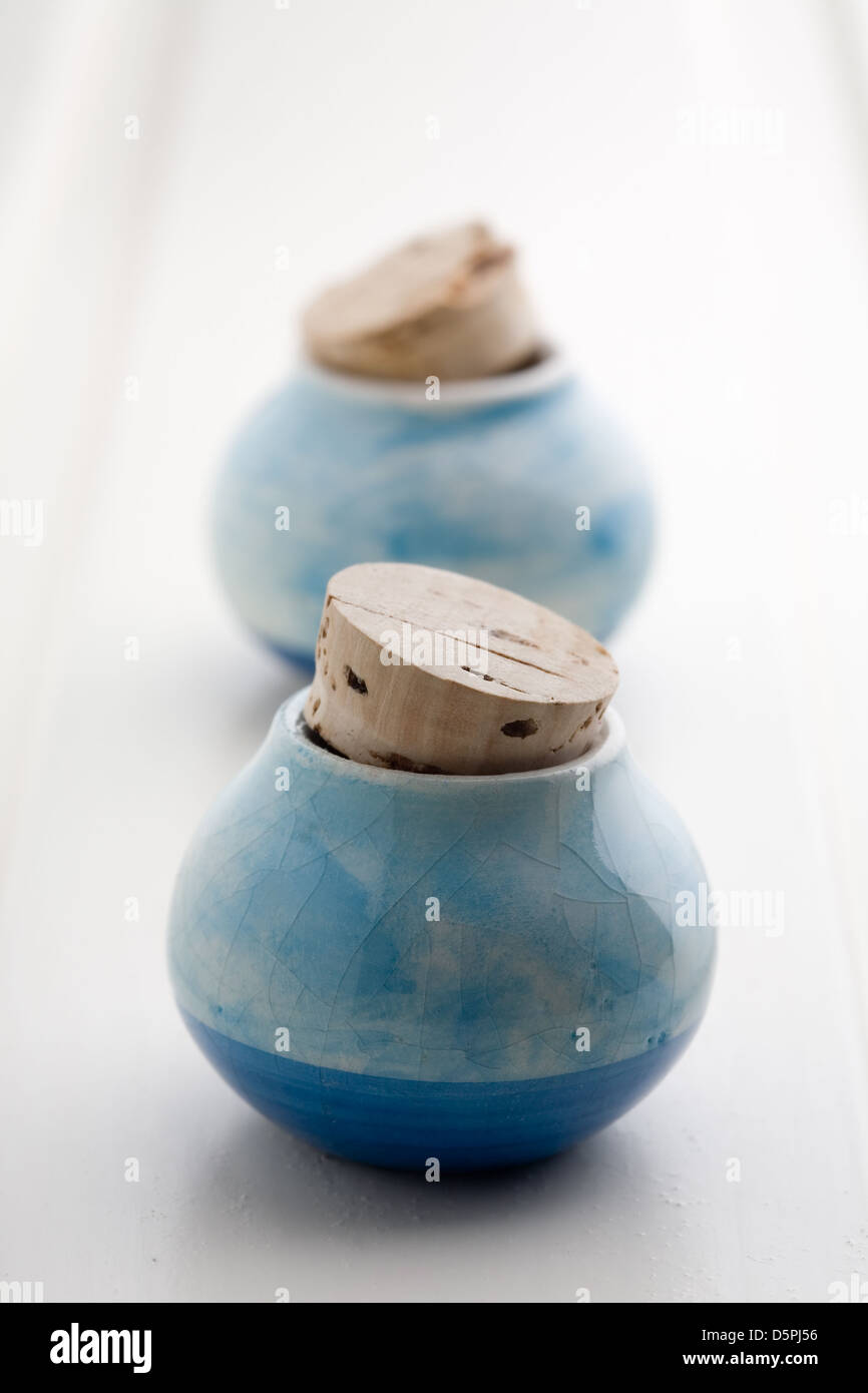 Blue little ceramic jars on white background Stock Photo