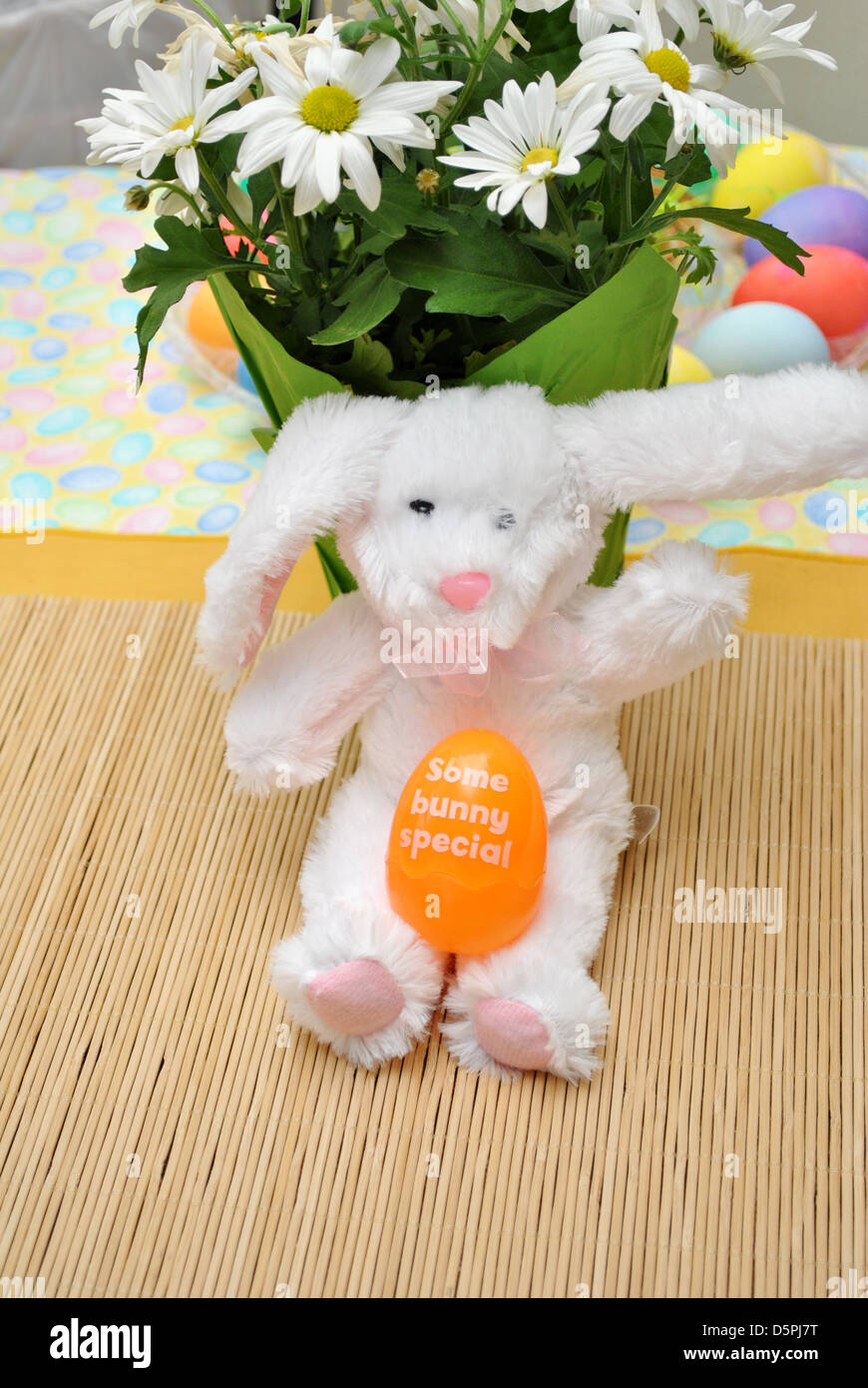 Spring Easter Bunny with a Toy Orange Egg Stock Photo