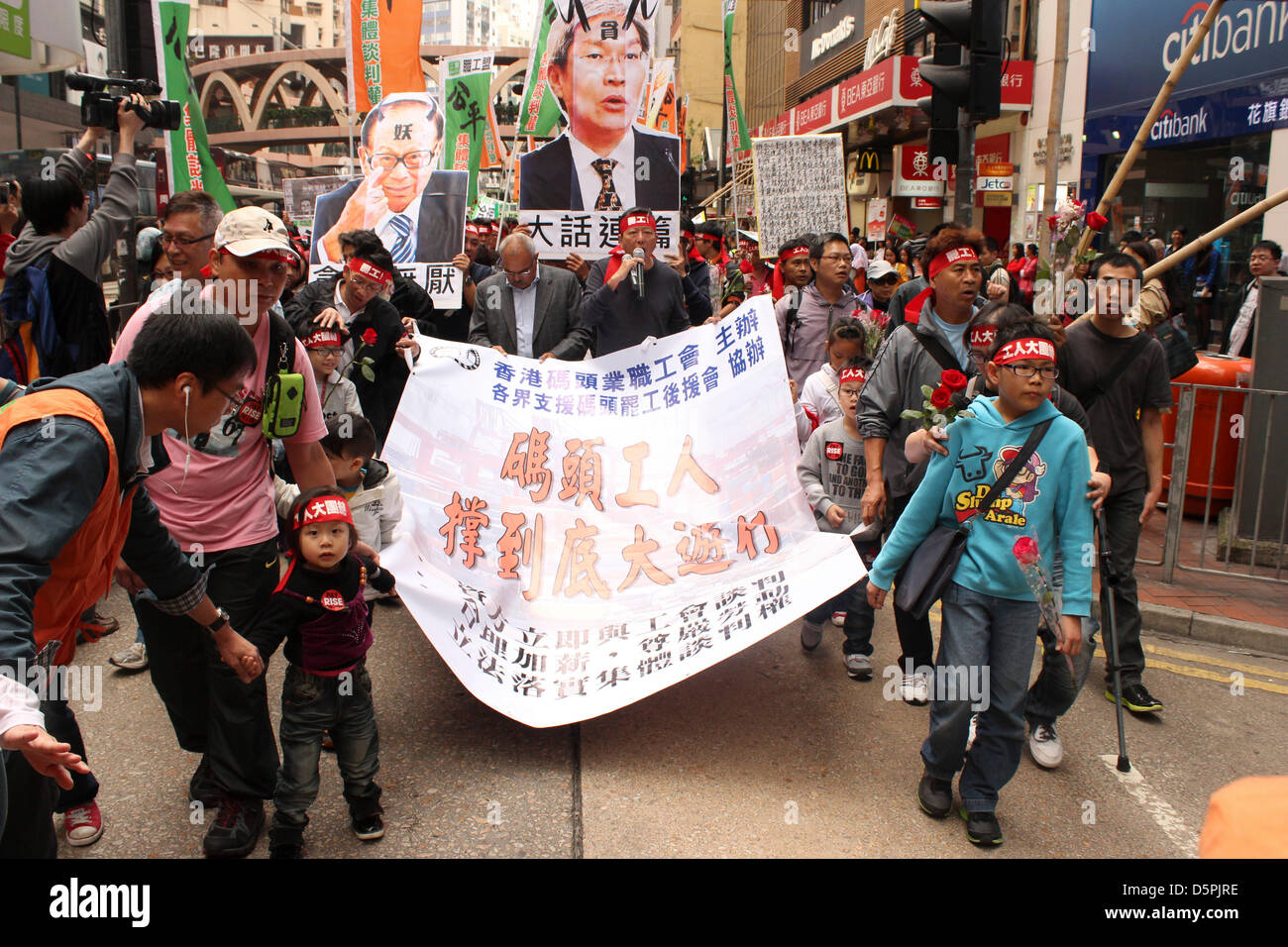 Causeway Bay, Hong Kong. 7th April 2013. Hong Kong legislator and union leader Lee Cheuk-yan (centre with microphone) leads march in support of local dock strikers. Credit: Robert SC Kemp/Alamy Live News Stock Photo