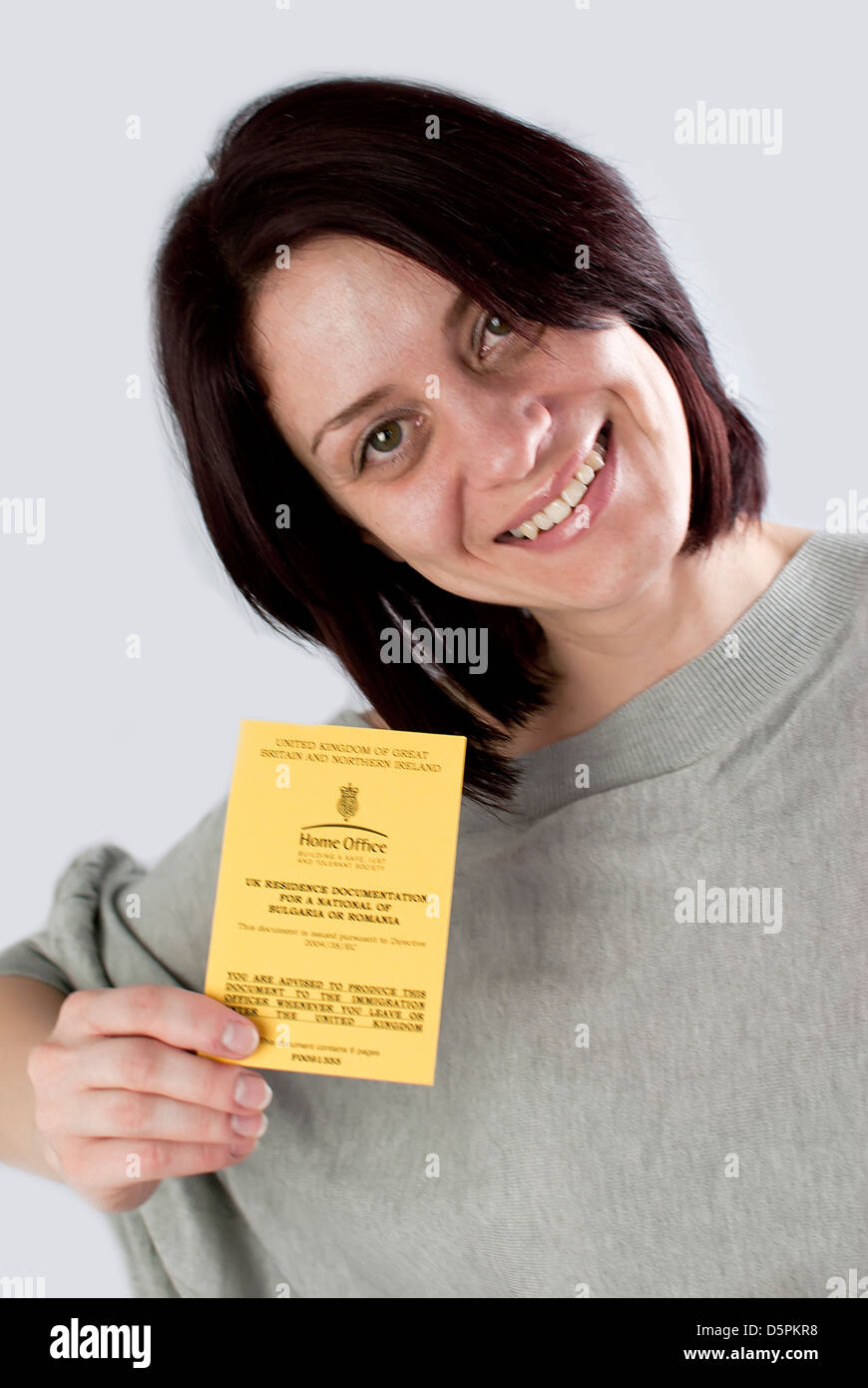 bulgarian immigrant holding uk work permission card for bulgarians and romanians Stock Photo