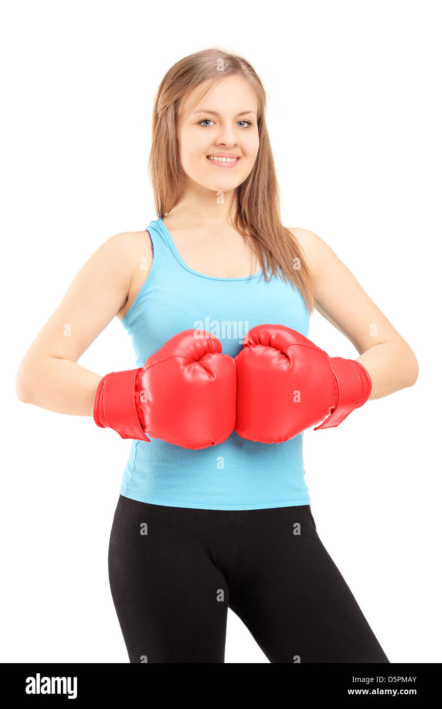 Young smiling female athlete wearing red boxing gloves and posing isolated on white background Stock Photo