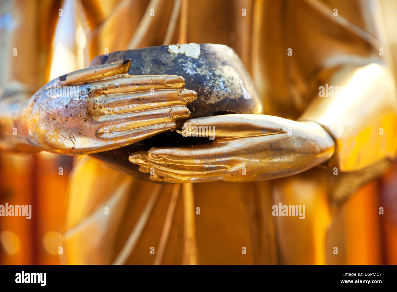 Golden Buddha hands Stock Photo