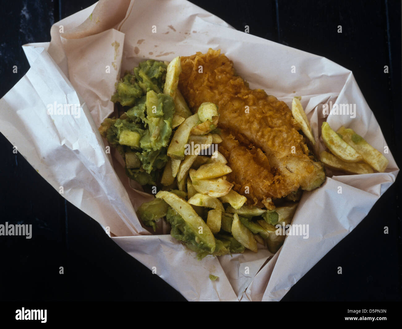 Takeaway Fish and chips with mushy peas wrapped in white paper Stock Photo