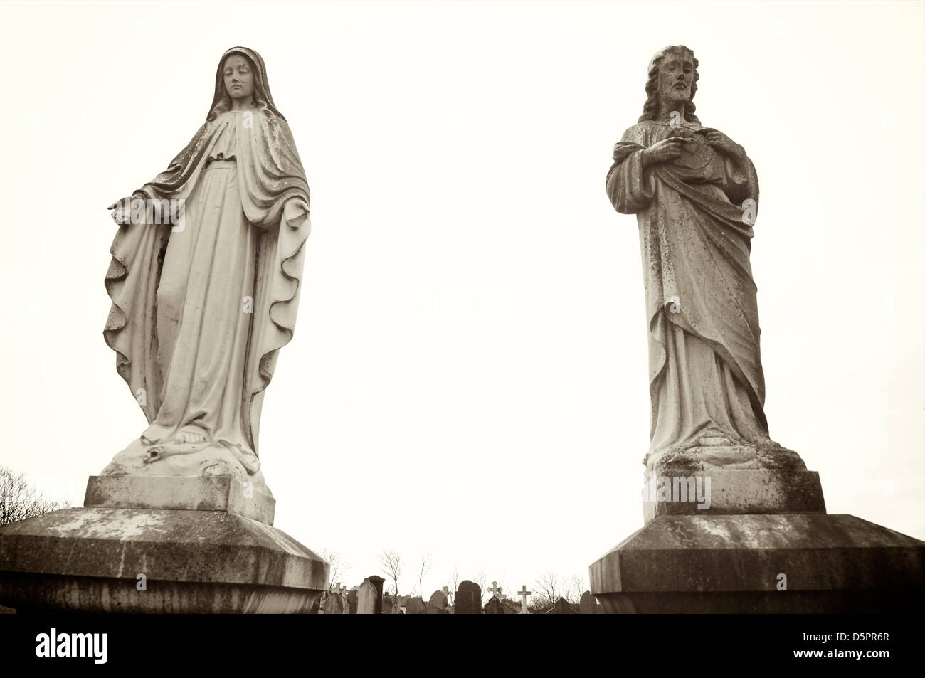 Statues of the virgin Mary and Christ on cemetery grave Stock Photo Alamy