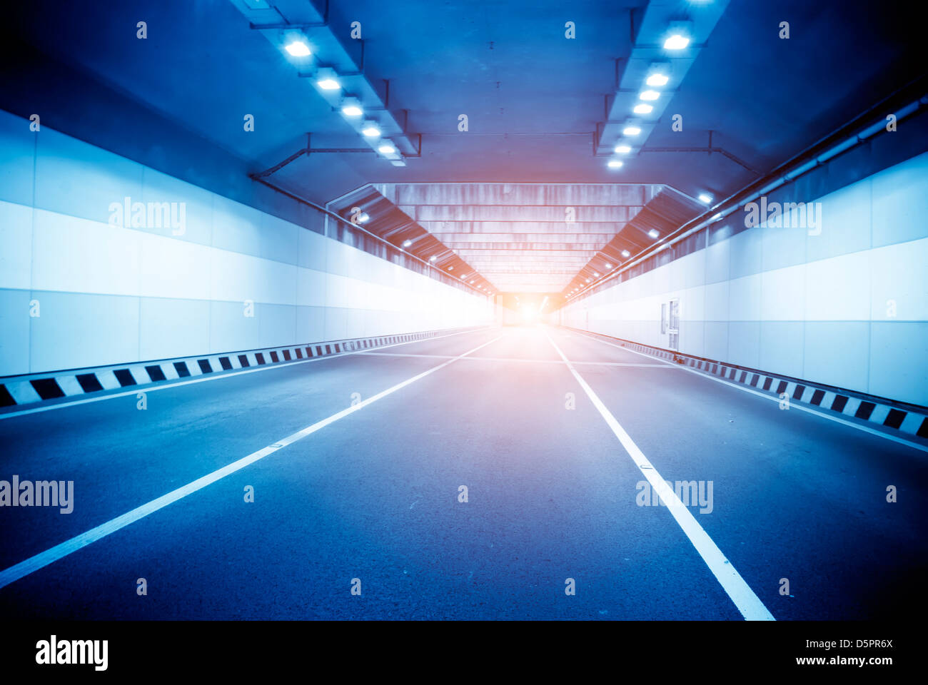 inside the tunnel with forward arrow sign and blurred speed motion Stock Photo