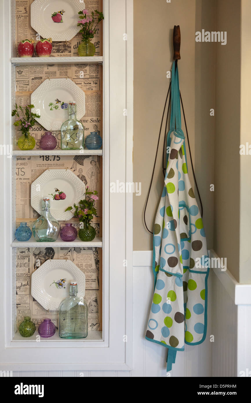 Apron hanging on hook in kitchen, shelves Stock Photo Alamy