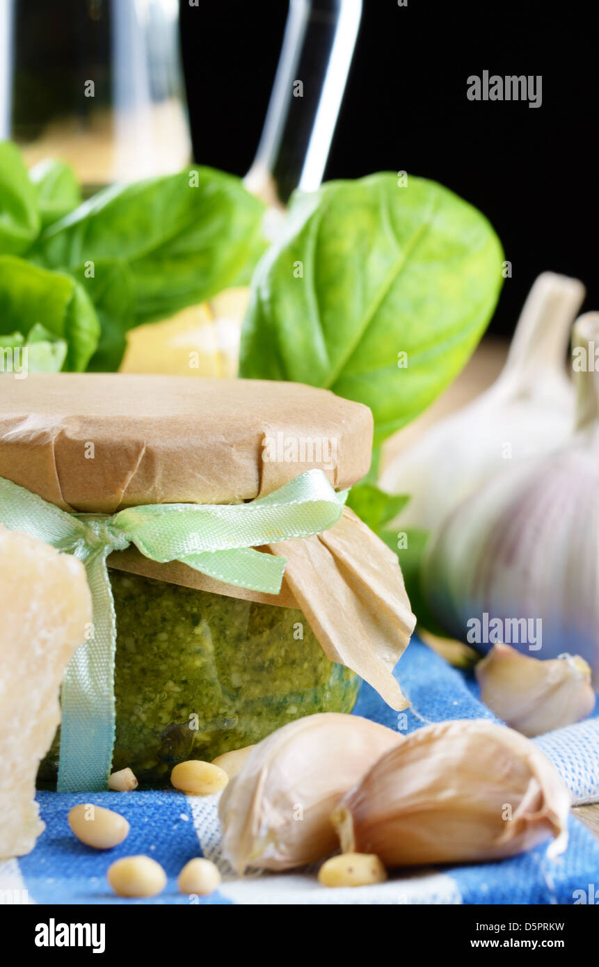 Homemade pesto sauce and ingredients on kitchen table Stock Photo