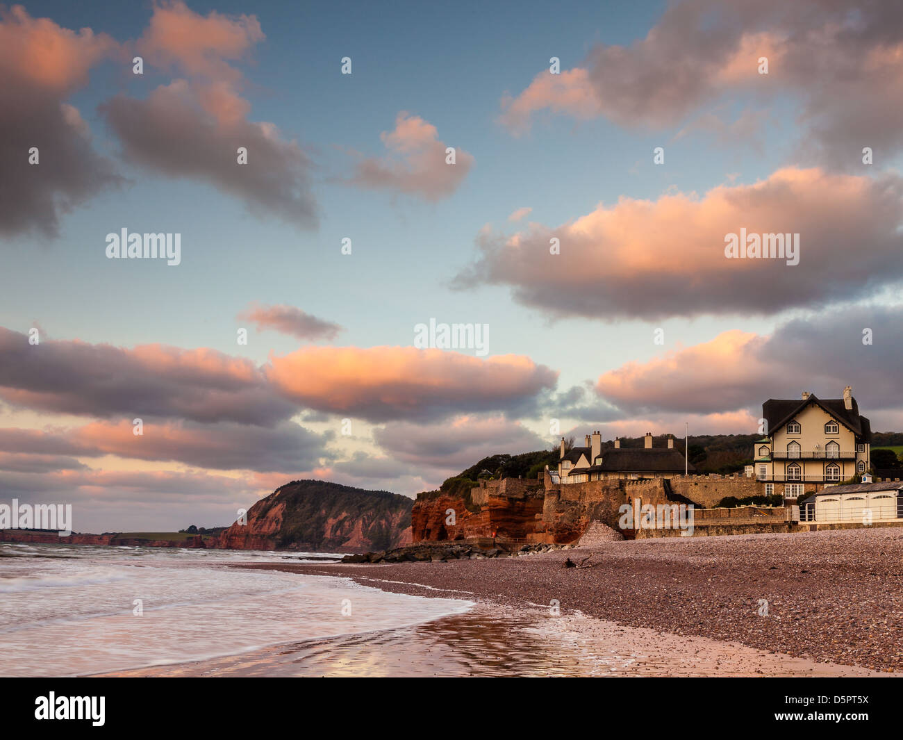 Sidmouth beach at sunrise, looking towards Jacobs Ladder Beach Stock Photo