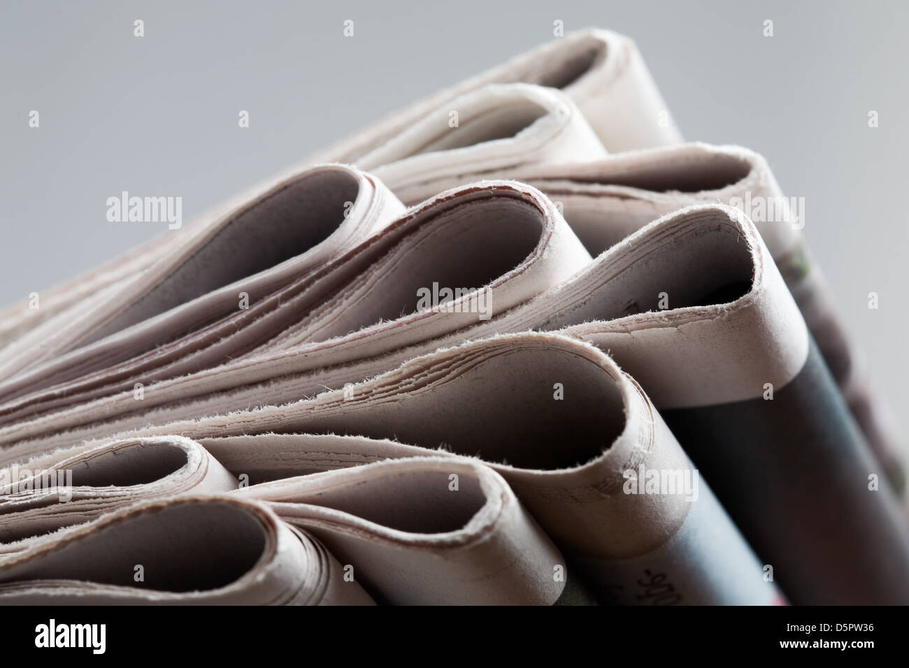 Folded newspapers on brown wooden table Stock Photo