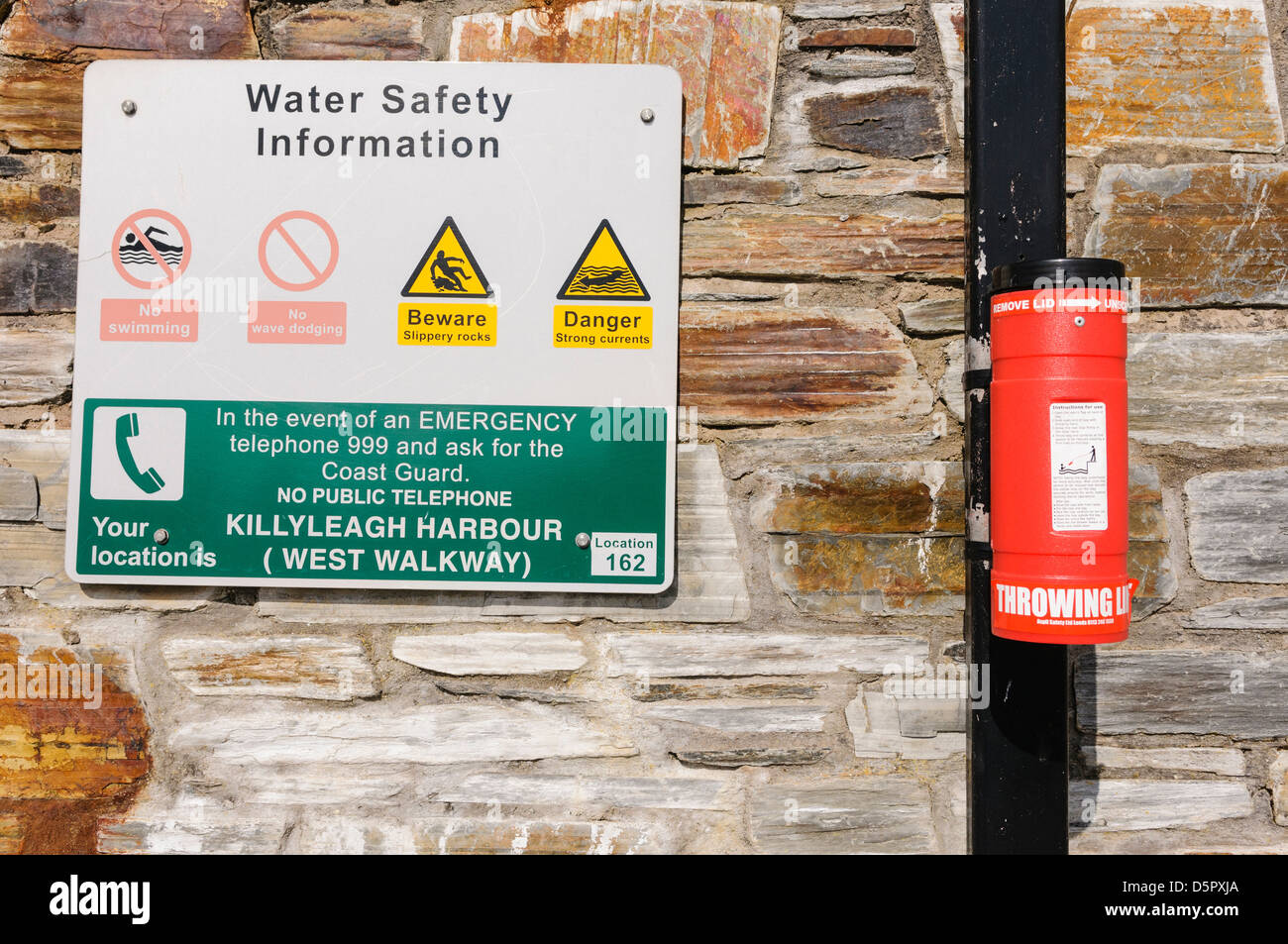 Emergency throwing line on a harbour wall Stock Photo