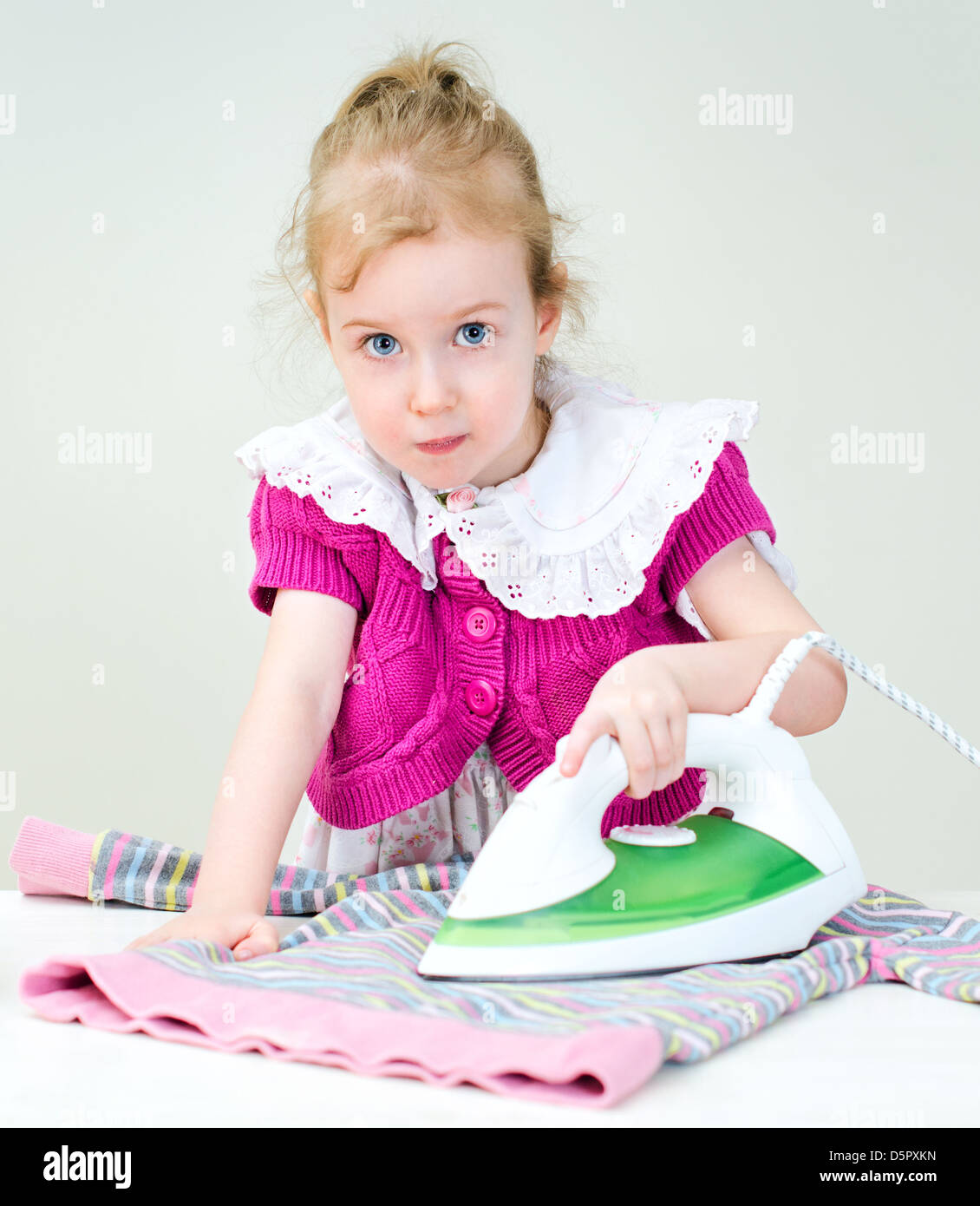 Cute little girl ironing clothes Stock Photo Alamy