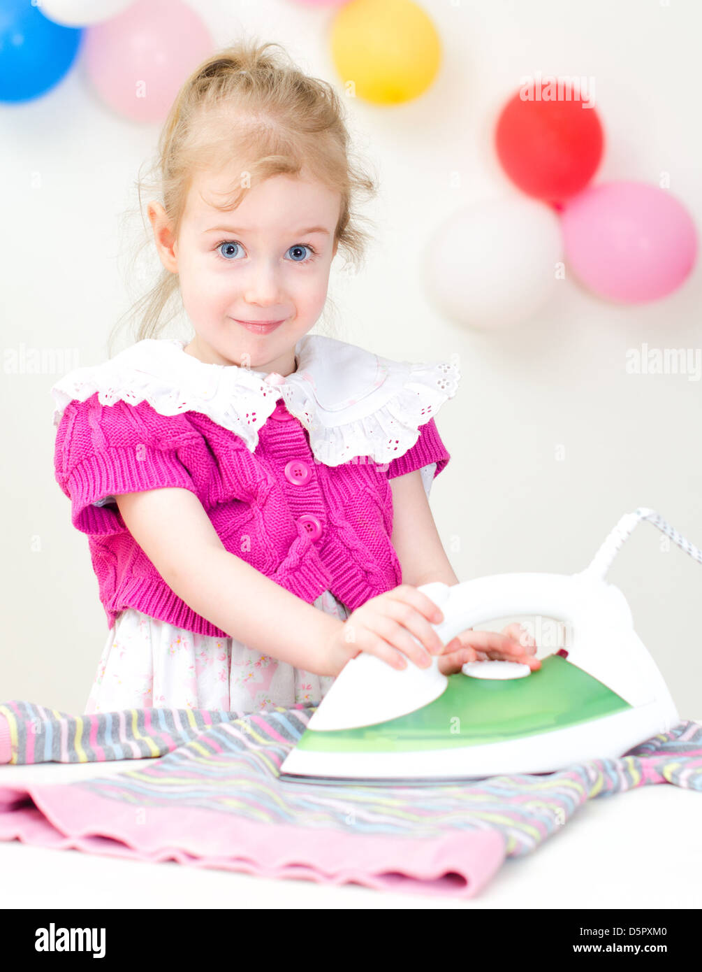 Cute little girl ironing clothes Stock Photo Alamy