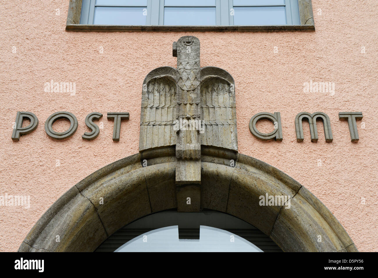 Stone eagle sculpture above archway on German post office Stock Photo