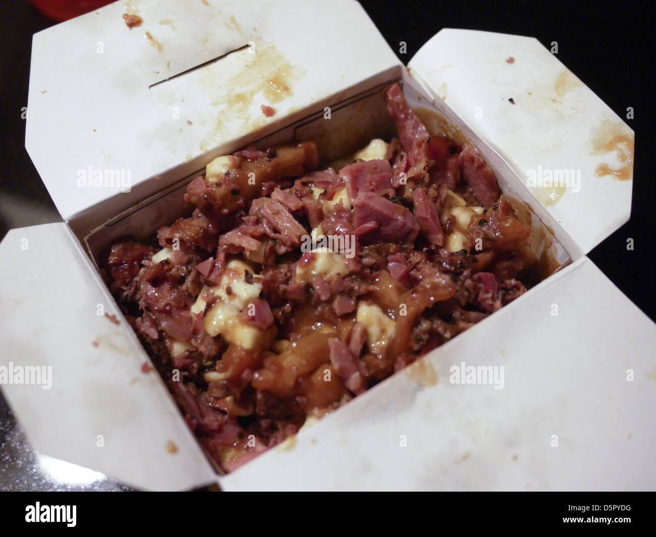 gravy fries ham cheese takeout box Stock Photo