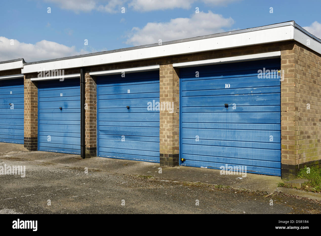 Row of single garages with blue doors Stock Photo