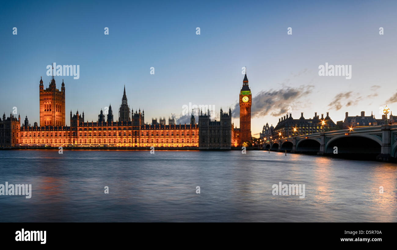 Night time at Westminster Bridge in London with Big Ben and the houses of parliament illuminated. Stock Photo