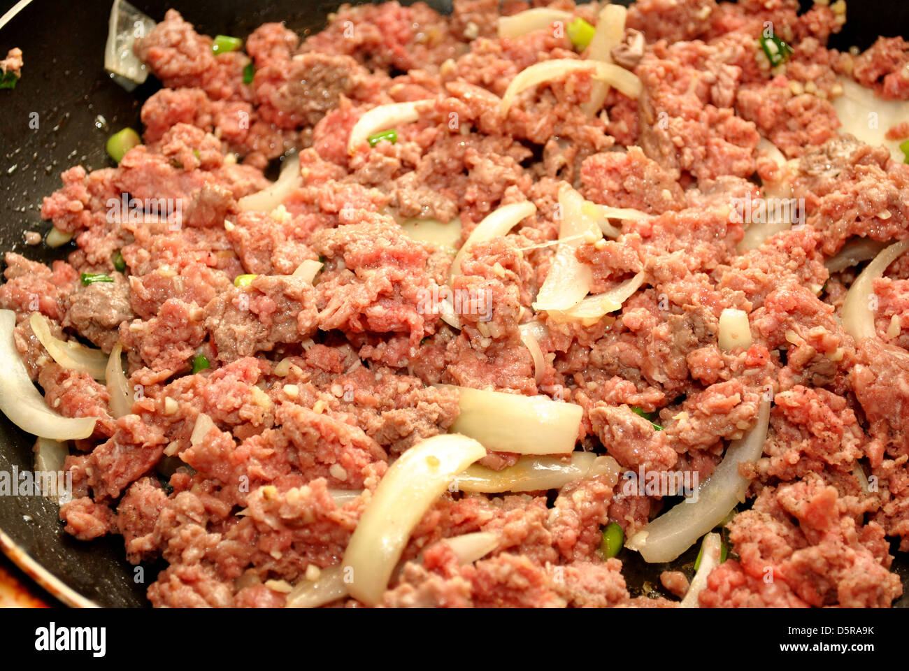 Ground Beef Cooking in a Fry Pan with Onions Stock Photo Alamy