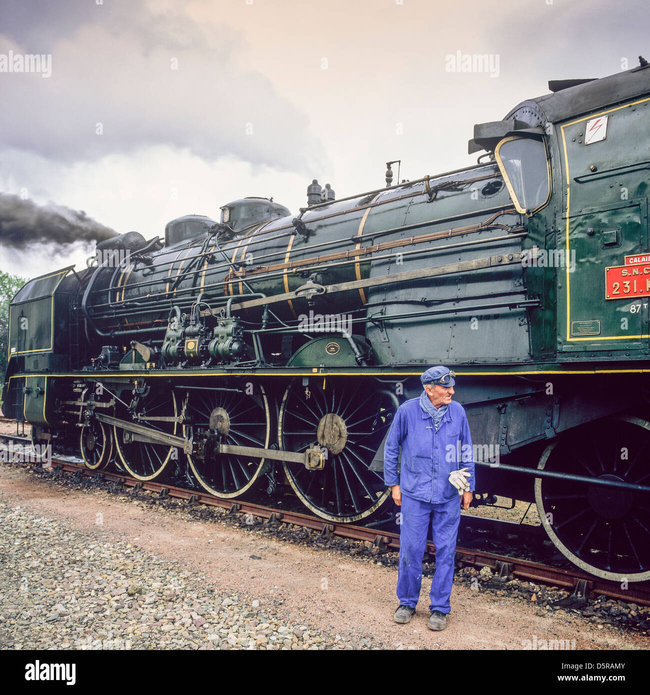 Engineer with historic steam locomotive "Pacific PLM 231 K 8" of "Paimpol-Pontrieux" train Brittany France Europe Stock Photo