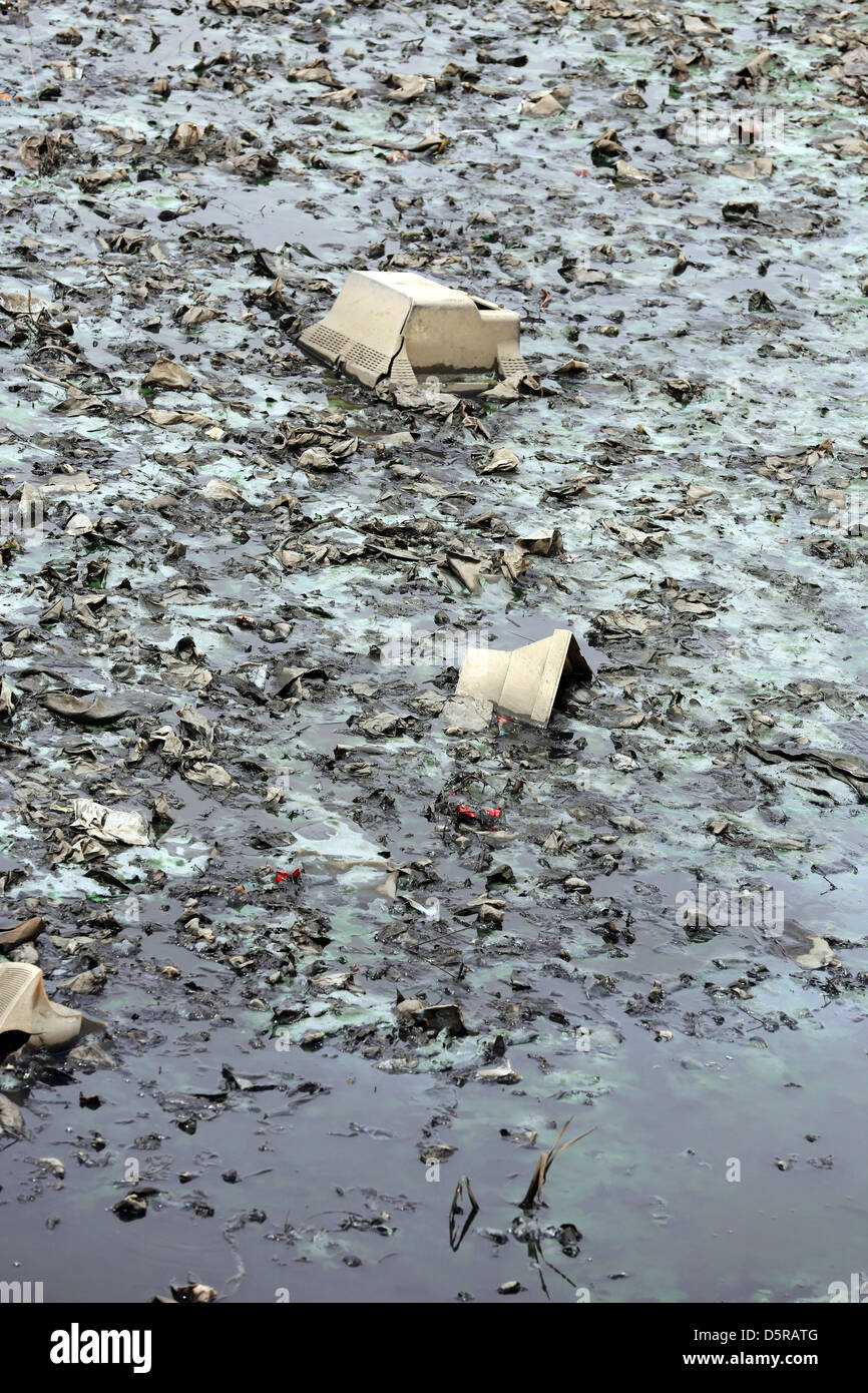 Computer monitors, e-waste and other rubbish dumped in the waters of a lagoon in Accra, Ghana Stock Photo