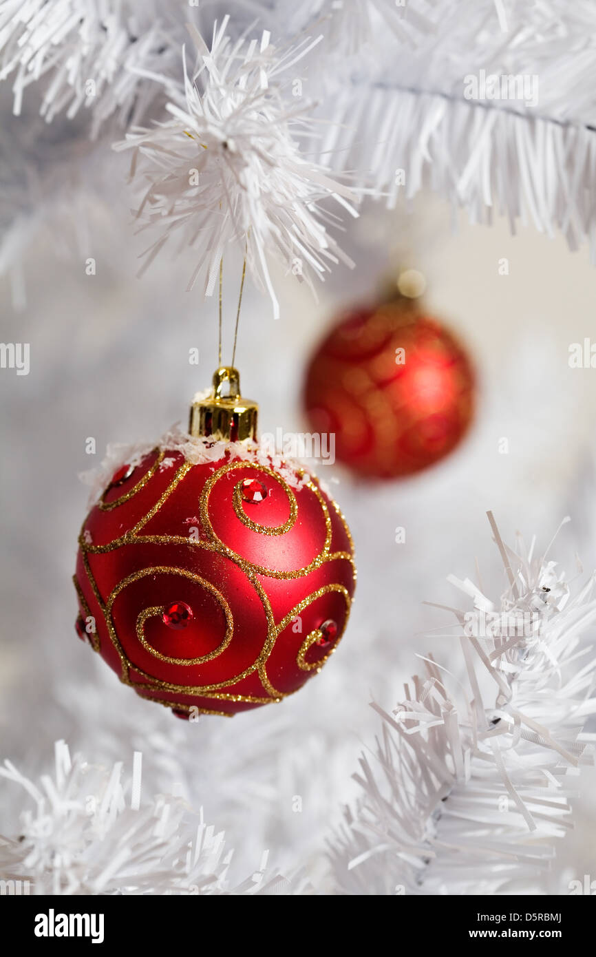Red christmas decorations on white christmas tree Stock Photo - Alamy