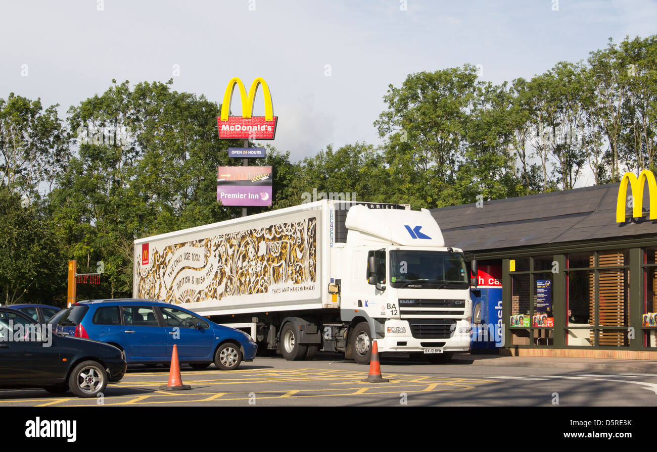 An articulated lorry in MacDonalds livery making an early morning delivery at a MacDonalds restaurant in Newport, Wales. Stock Photo