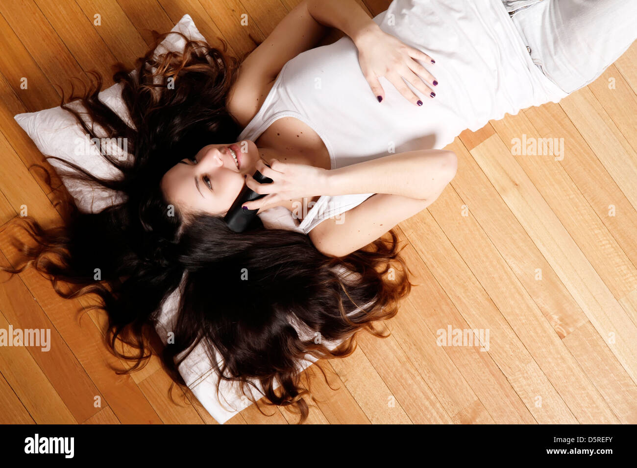 A young hispanic girl talking on the phone Stock Photo - Alamy